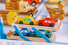 Wooden cars and other toys made by an artisan on the market. New eco materials for children and crea