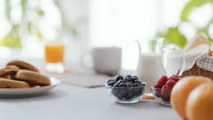 Delicious breakfast at home: fresh fruit and coffee on the kitchen table