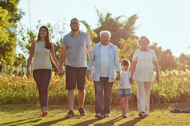 Family time is never quite enough. a <strong>happy</strong> family going for a walk together in the park