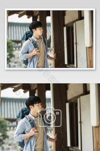 城市背包客手扶传统建筑看前方图片