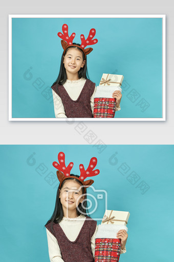 圣诞节抱着圣诞礼物的小女孩横图图片