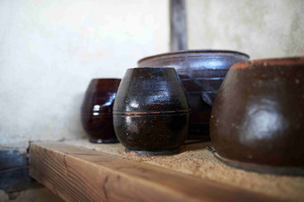 老厨房里的黑色旧陶罐实物摄影图