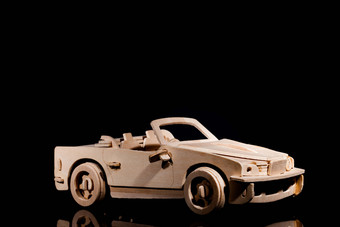 <strong>黑色背景</strong>木头汽车模型玩具摄影图