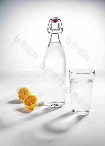 透明水杯玻璃瓶橙子静物场景摄影图