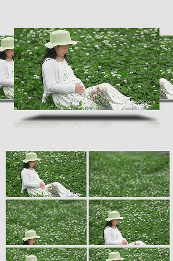 人物形象孕妇坐在花丛中抚摸肚子实拍4K图片