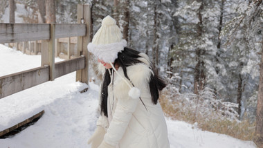 东方人像女孩雪地打雪仗开心玩耍实拍