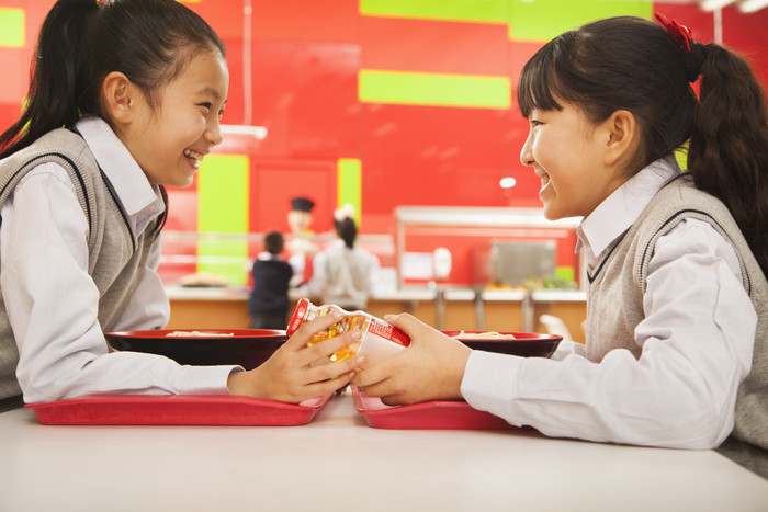 学校饭堂食堂学生小女孩好朋友吃饭对视牛奶