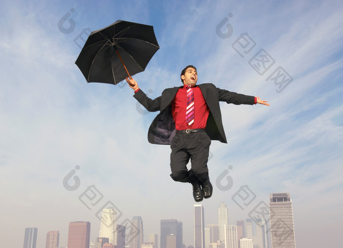 空中拿着雨伞的男人