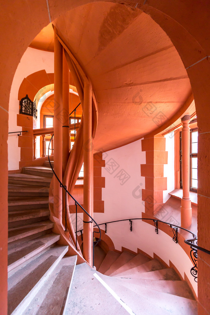 暖色调房子内的螺旋楼梯摄影图