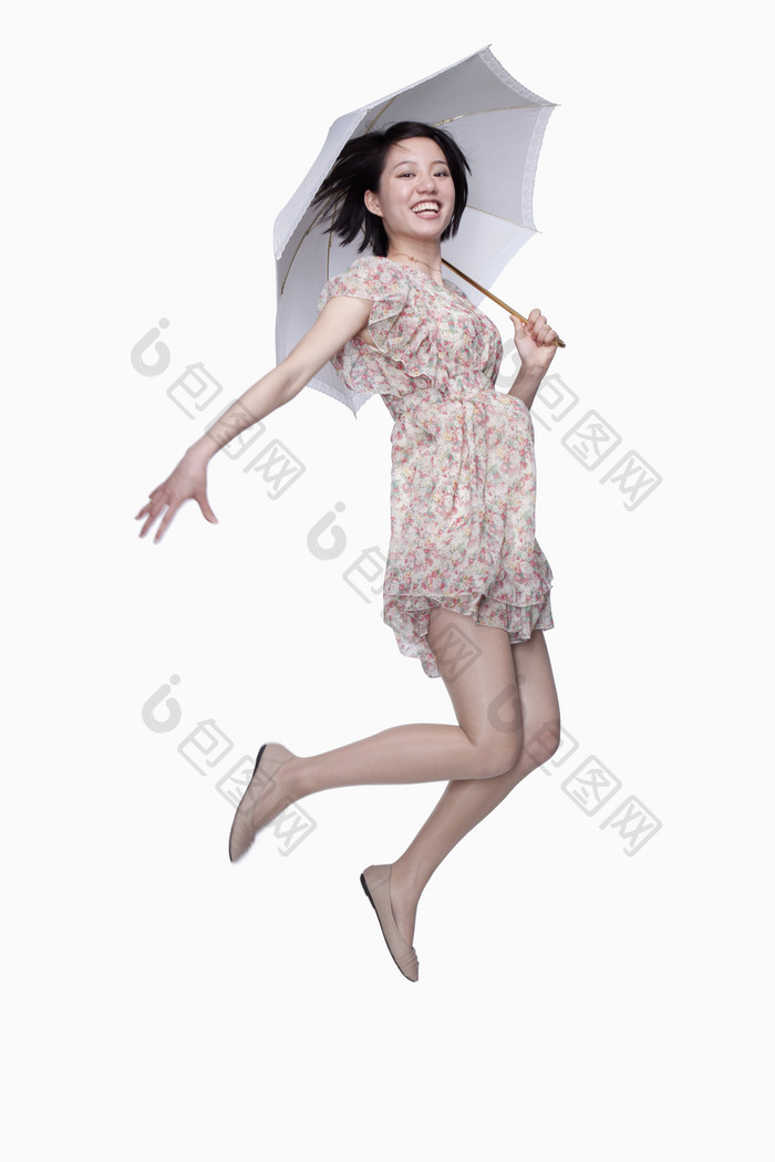 夏天撑伞遮阳防晒花裙子女人成熟的跳跃摄影