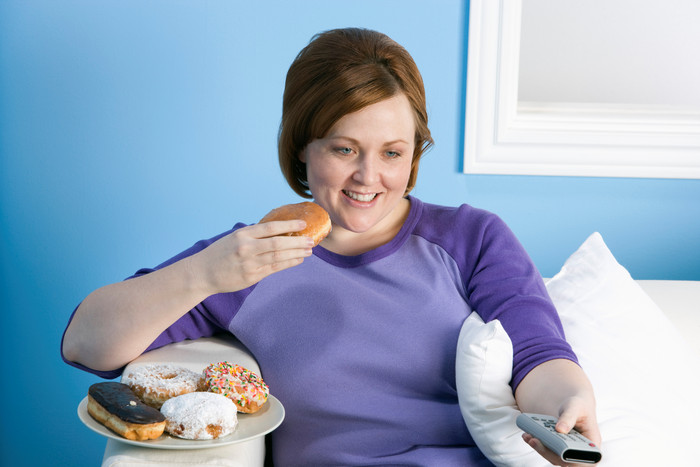 蓝色调吃东西的胖女人摄影图