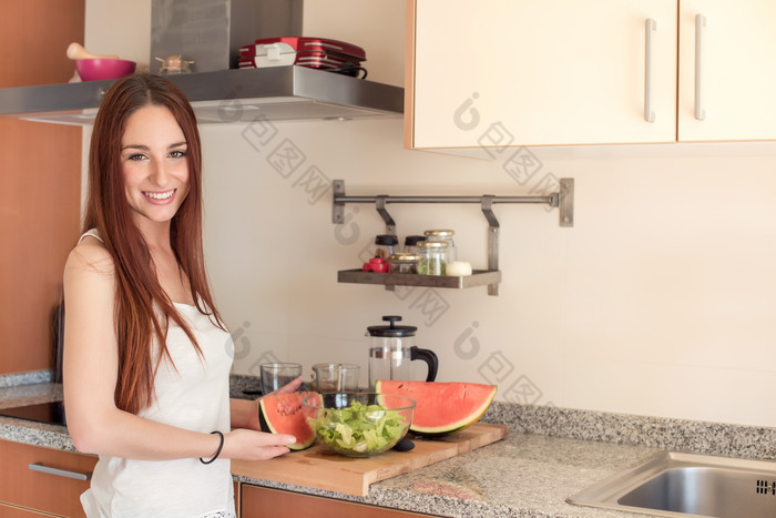 女人拿着厨房案板上的水果