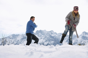 雪地玩雪的夫妻摄影图