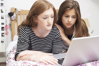 两个女孩严肃的看电脑