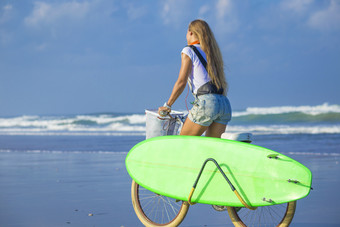 清新风格海边骑车的女人摄影图