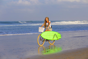 清新海边骑车的女人摄影图
