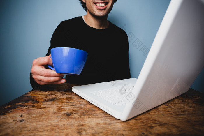 开心看电脑喝咖啡的人