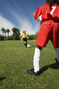 草地上踢足球的儿童