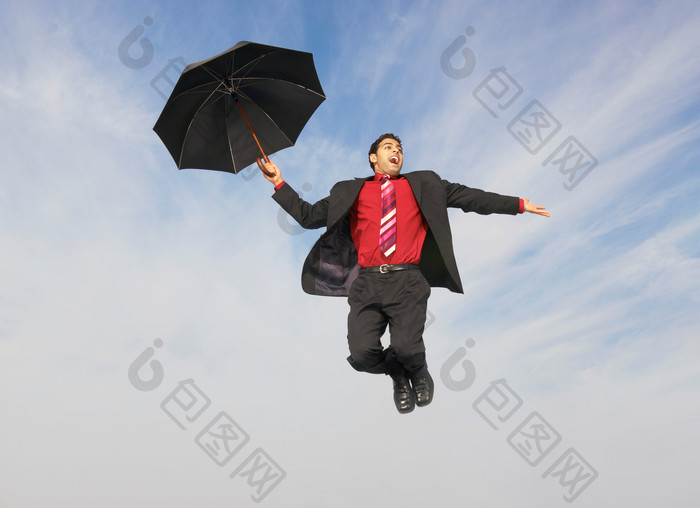 拿雨伞跳跃的商务男人