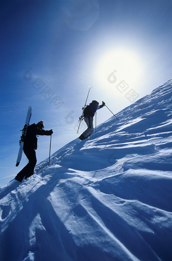 蓝色调登山的两个人摄影图