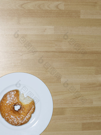桌面上白盘里的甜甜圈