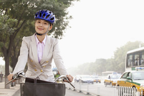 戴头盔骑自行车的女性
