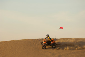暗色调沙漠中的四轮摩托摄影图