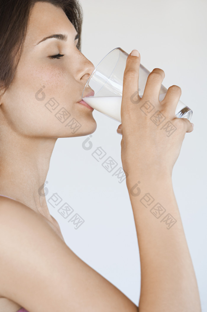 灰色调喝牛奶的女生摄影图
