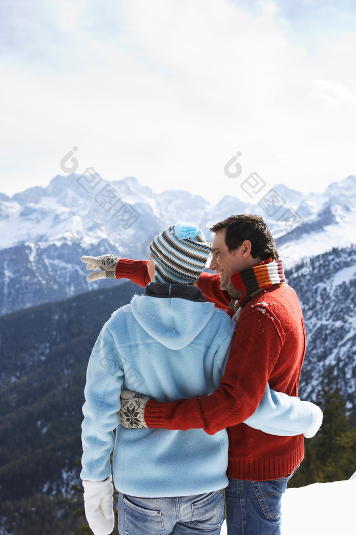 蓝色调登雪山的夫妻摄影图