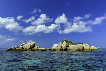 蓝天白云下海滩美丽海石摄影图