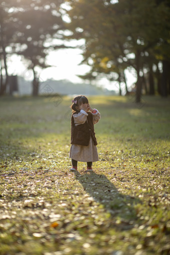 在公园<strong>草地</strong>上遮住眼睛的可爱女孩