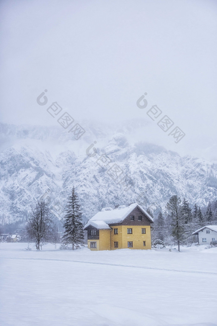 冬季寒冷积雪的小屋和大山