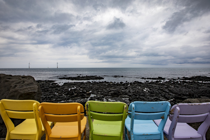 晴朗海边多彩椅子文艺摄影图