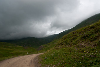阴云下的山间小路摄影图