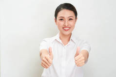 年轻的亚洲妇女显示拇指手势使用双手.