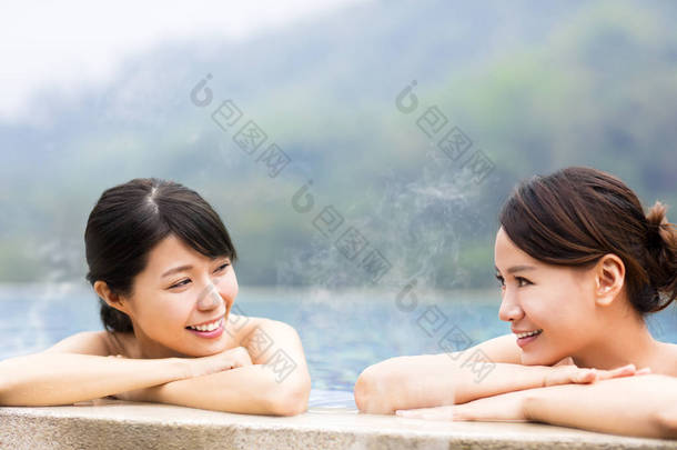 幸福的年轻女人在温泉中休息