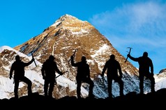 Evening view of Mount Everest and silhouette of climbers