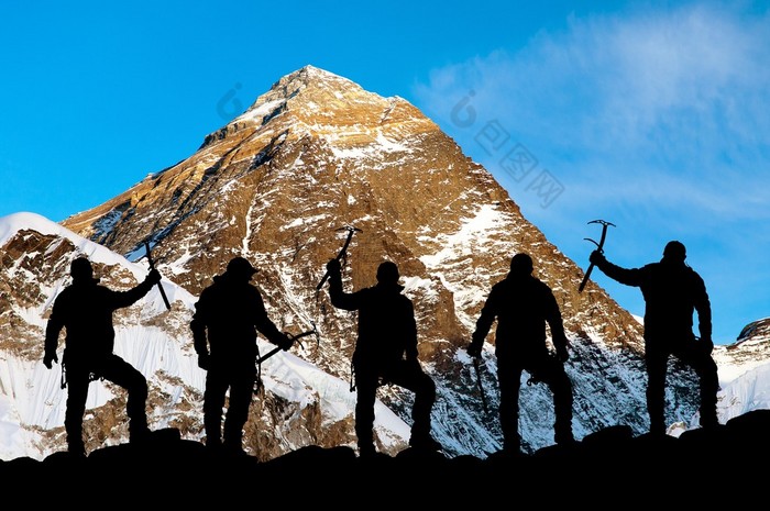 Evening view of Mount Everest and silhouette of climbers