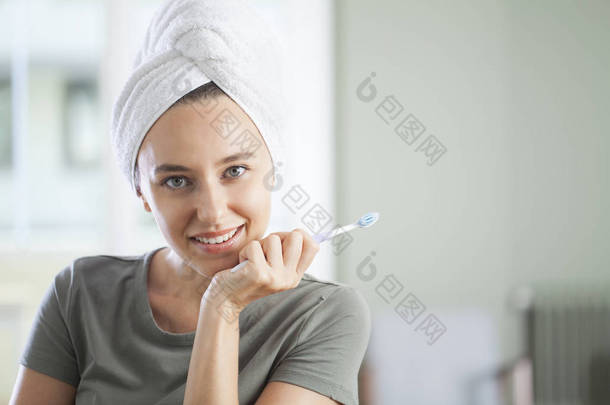 一个笑着拿着牙刷的可爱女人的画像 