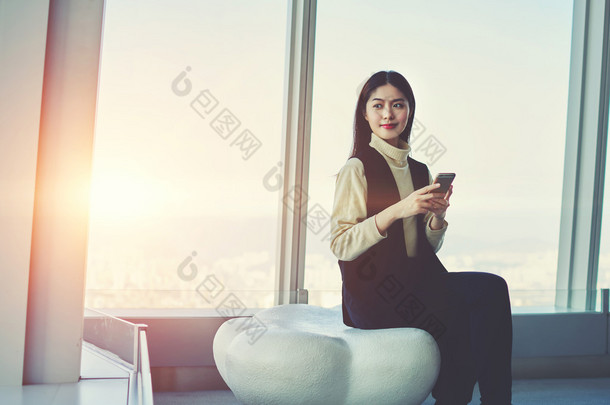 Woman checking e-mail on cell phone