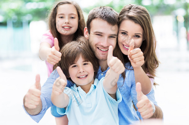 Happy young family thumbs up