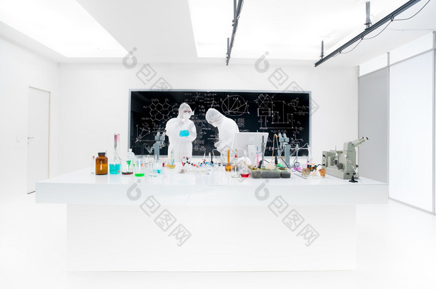 Two lab technicians working wearing masks