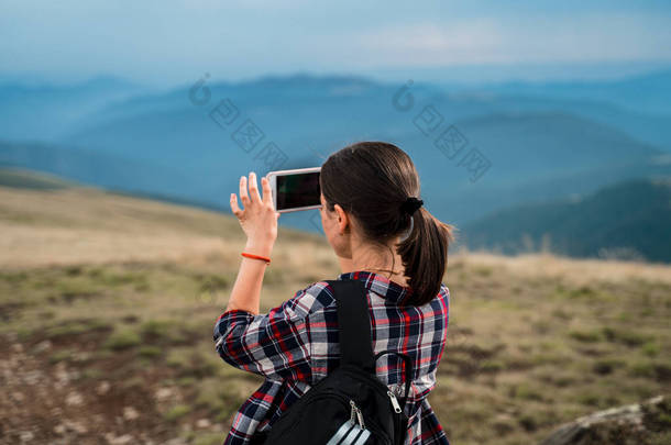 游客正在拍摄手机上惊人的景色。喀尔巴阡山, 乌克兰