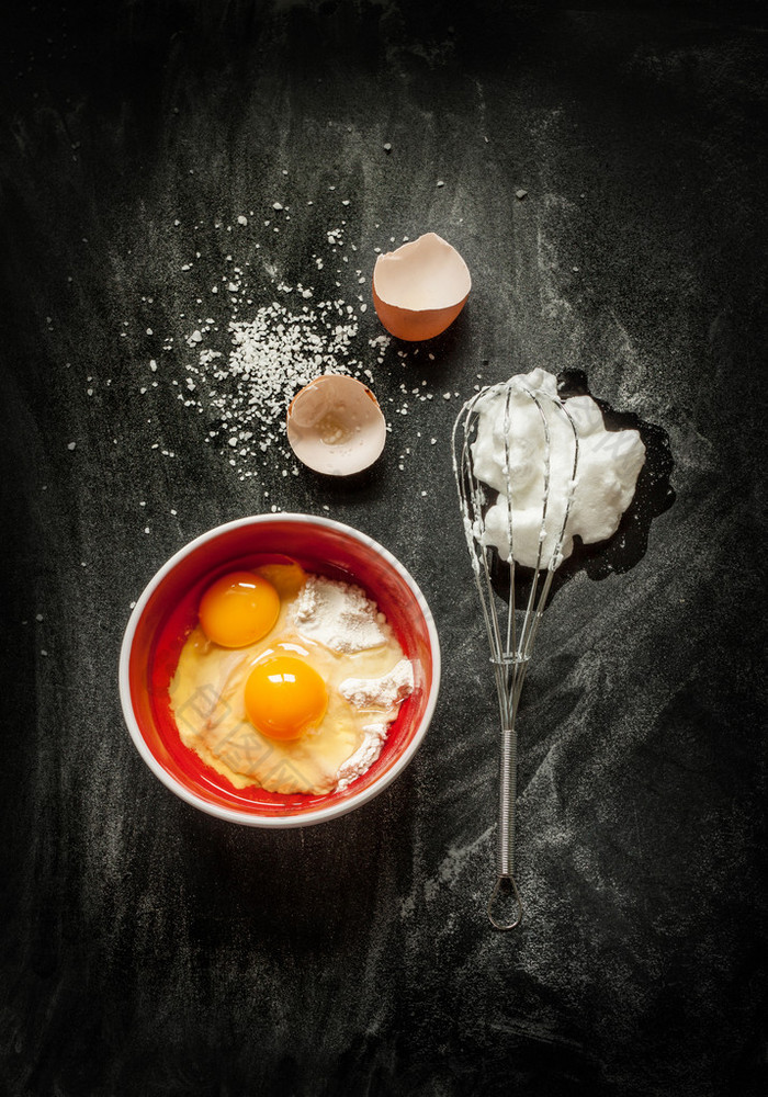 Baking cake ingredients on black chalkboard