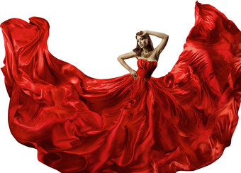在红色的礼服，丝绸晚礼服，挥舞着面料时装模特舞蹈跳舞的女人图片