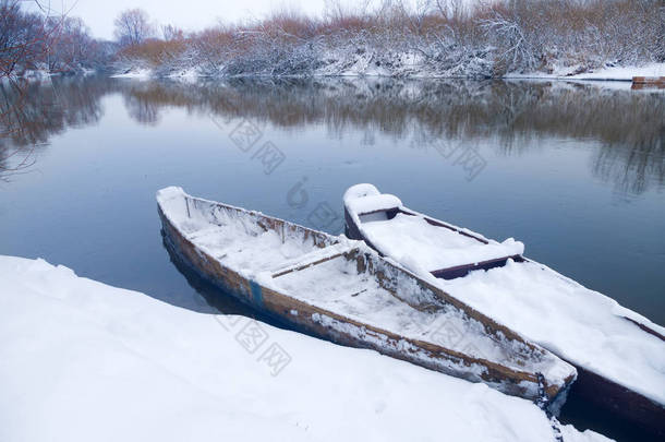在雪河岸边的小船