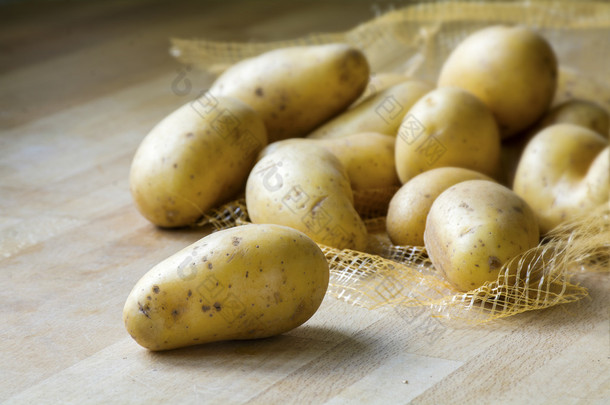 new potatoes on a wooden kitchen board