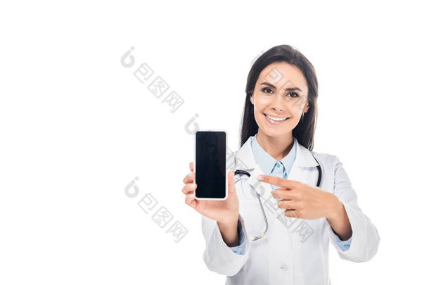 医生在白色外<strong>套用</strong>听诊器指向用手指在智能手机与空白屏幕查出在白色