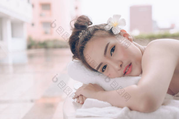 美丽的亚洲妇女放松与手按摩治疗在美容 spa。年轻快乐的女孩在温泉沙龙得到按摩。推拿疗法疗愈医学与保健理念. 