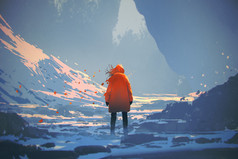 后方的看法的橙色件温暖的外套站在冬季景观的女人